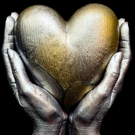 Image of a pair of hands holding a gold heart